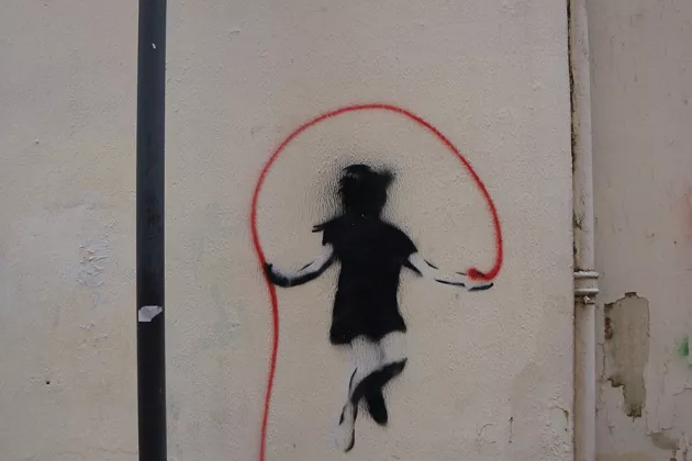 Graffiti of a girl jumping rope 