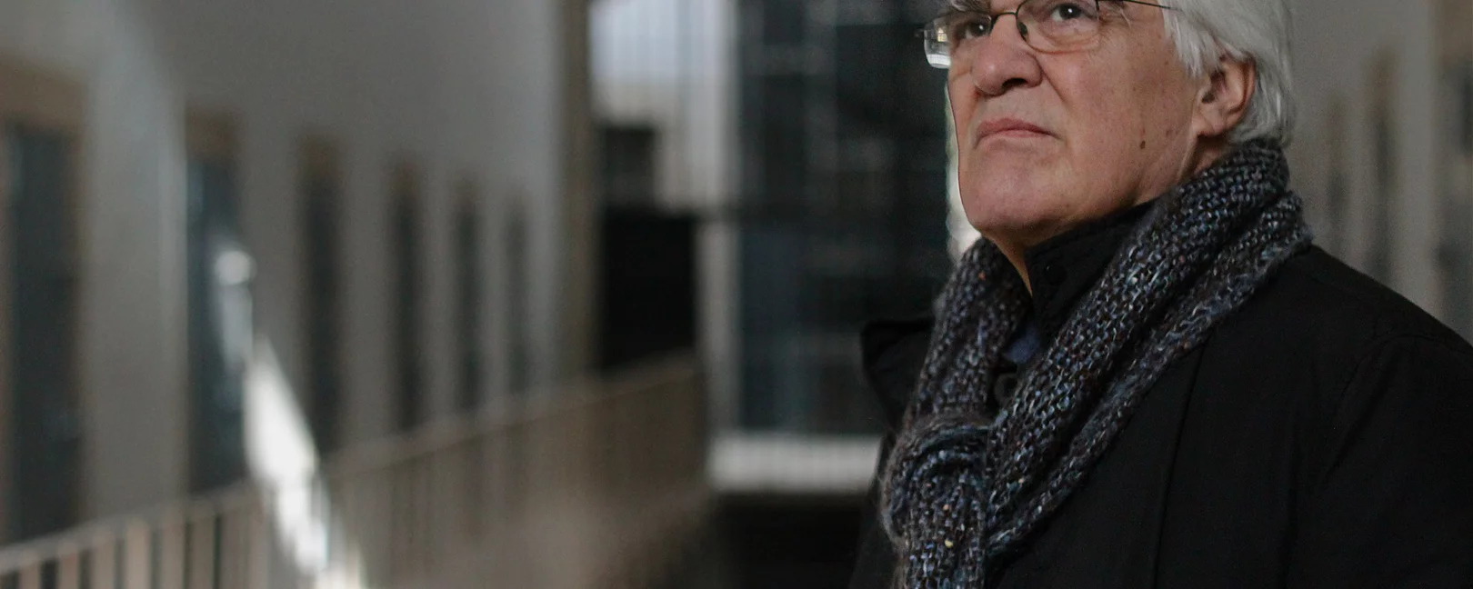 Old man standing in a hallway 