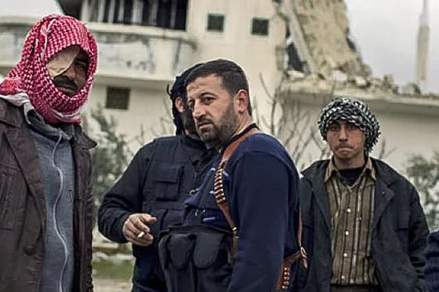 Free Syrian Army soldiers gather outside a house destroyed in fighting against President Assad's forces in Sarmin, north of Syria, Tuesday, Feb. 28, 2012. Free Syrian Army soldiers gather outside a house destroyed in fighting against President Assad's forces in Sarmin, north of Syria, Tuesday, Feb. 28, 2012.