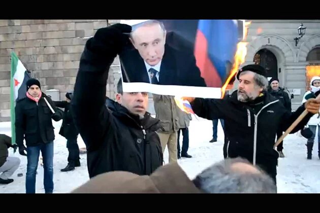 Syrians Burning Vladimir Putin Picture and Russian Flag During Protest in Sweden Syrians Burning Vladimir Putin Picture and Russian Flag During Protest in Sweden