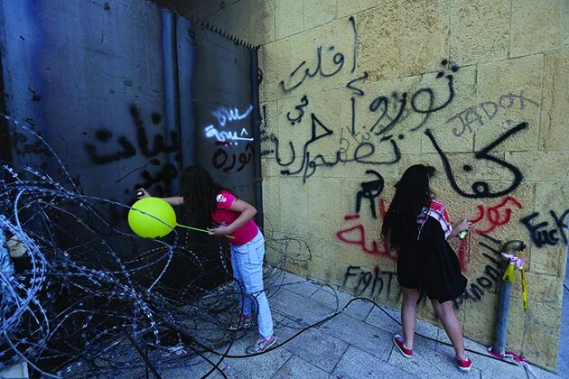 Women doing graffiti on Beirut walls during the 2016 garbage demonstration in Beirut